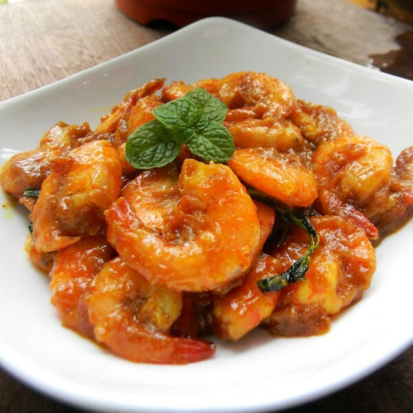 Fried shrimps with basil on hot plate